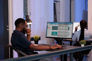 Trading manager looking at stock market exchange statistics with global money trade and profit on computer screen. Analyzing real time forex data report to make hedge fund investment.