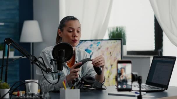 Tech Product Enthusiast Reviewing Modern Headphones While Recording Video Smartphone — Vídeos de Stock