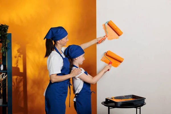Young People Painting Walls Orange Color Doing Housework Renovation Paintbrush — Fotografia de Stock