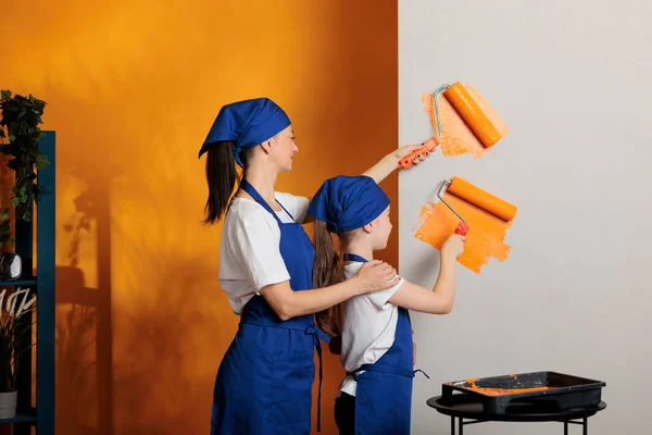 Mother Girl Painting Orange Walls Using Dye Color Redecorate Apartment — Foto Stock