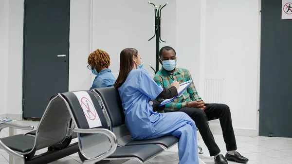 Senior Woman Face Mask Attending Checkup Appointment Doctor Hospital Reception — Zdjęcie stockowe