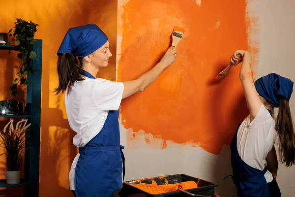 Adult Child Painting Orange Walls Color Paint Renovating Tools Brush — Stockfoto