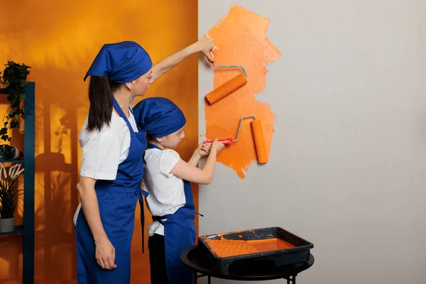 Young People Painting Walls Orange Color Paint Roller Brush Doing — Fotografia de Stock