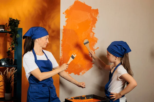 Woman Little Girl Using Orange Paint Walls Brush Renovate House — Stockfoto