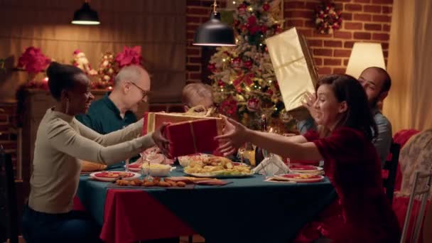 Happy Multiethnic Family Members Exchanging Gifts While Christmas Dinner Festive — Vídeo de stock