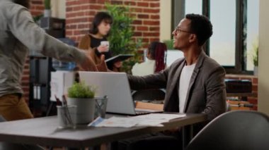 African american man analyzing business data research on laptop, working on professional report to send email. Office worker brainstorming ideas to plan presentation project with charts.