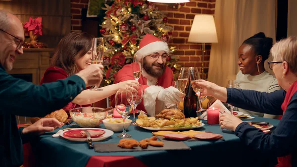Joyful Man Disguised Santa Claus Clinking Champagne Glass Family Enjoying — Stock Fotó