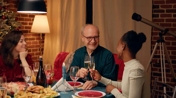 Festive Smiling Senior Man Clinking Glasses Young Woman Christmas Dinner — Stok fotoğraf