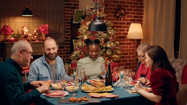 Festive Multiethnic Family Enjoying Traditional Home Cooked Food While Sitting — Stockfoto