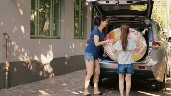 Mother Daughter Putting Luggage Car Trunk While Enjoying Holiday Field — Stok fotoğraf