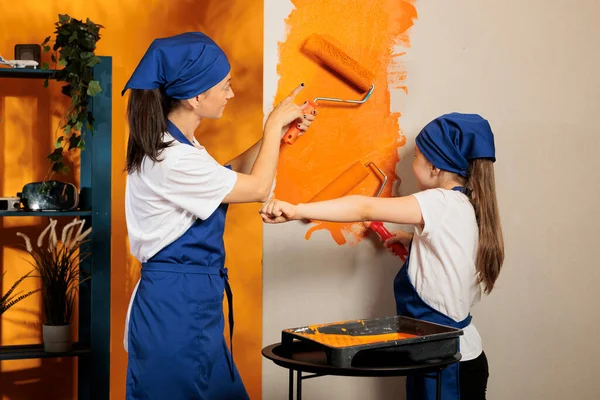 Mother Girl Painting House Walls Orange Color Paint Using Renovating — Fotografia de Stock