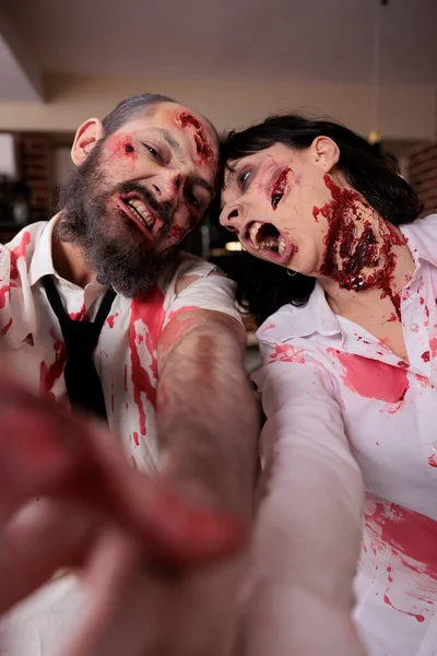 Portrait of dangerous walkers with bloody wounds hunting and attacking people in business office, eating brain and looking horrific. Undead gory evil walkers with spooky scratches, sinister terror.
