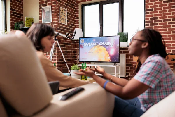 Upset Multiracial Women Sitting Sofa Living Room While Discussing Videogames — 图库照片