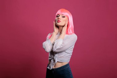 Portrait of sensual woman with sexy makeup look and trendy style, feeling confident and attractive in front of studio camera. Glamour fashion icon with pink hairstyle and beautiful face.