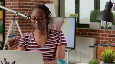 Shopaholic person doing online shopping with credit card on laptop, buying clothes from online retail store website. Female customer making payment and electronic transaction, remote work.