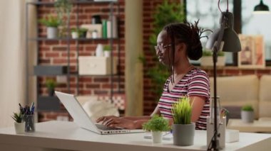 Freelancer woman browsing internet on laptop to do remote work, using online network connection on computer. Employee working remotely on pc to plan startup freelance job at home office.