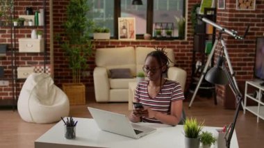 Portrait of modern woman texting messages on smartphone, taking break from remote work with laptop. Female freelancer student browsing internet on social media mobile app, working remotely.