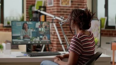 Company employee attending videocall business meeting on computer with webcam, talking to colleagues about remote work. Using online videoconference and remote teleconference call to chat.