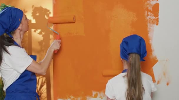 Small Family Painting Apartment Walls Orange Color Doing Renovation Work — Wideo stockowe