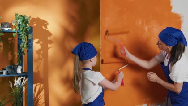 Family Painting Apartment Walls Orange Color Paint Working Interior Home — Stockvideo