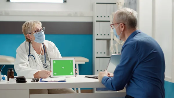 Physician Holding Horizontal Greenscreen Digital Tablet Appointment Senior Patient Chroma — Stockfoto