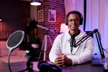 POV of content creator filming livestream podcast on camera, using podcast equipment to record conversation. Social media influencer recording live broadcast show for internet channel.