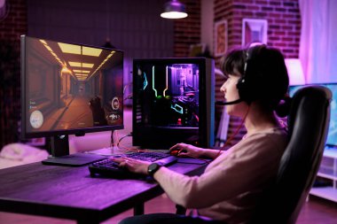 Content creator streaming live video games championship on computer, playing online game. Female player having fun with action rpg tournament gameplay on pc for entertainment.