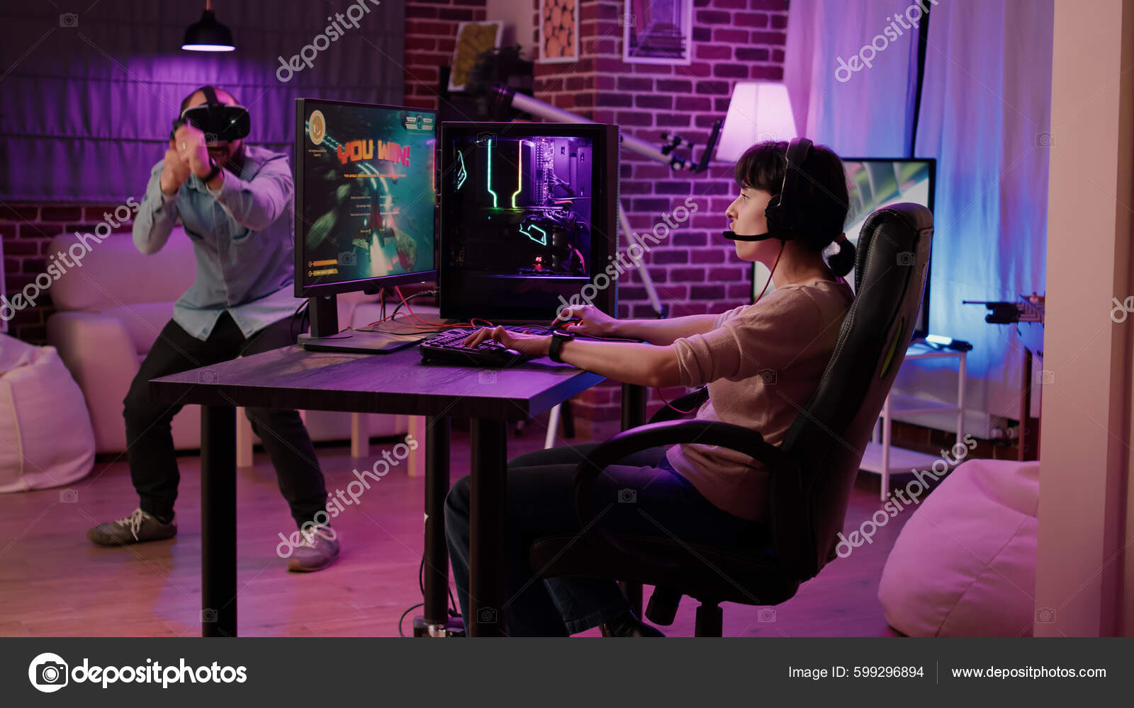 Competitive boyfriend and girlfriend playing video games funny Stock Photo