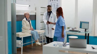 African american medic giving bottle of pills as prescription treatment, using antibiotics medication to help patient with healthcare recovery. Drugs medicament at medical appointment.