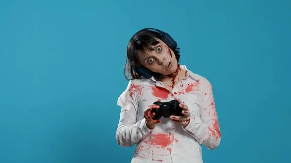 Brain Dead Spooky Looking Zombie Modern Controller Playing Blue Background — Stok fotoğraf