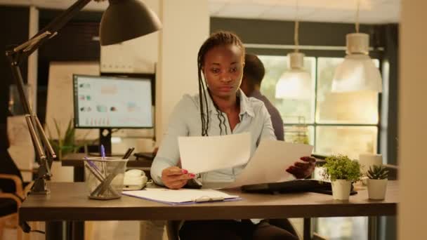 African American Woman Analyzing Business Paperwork Charts Data Research Work — Vídeo de Stock