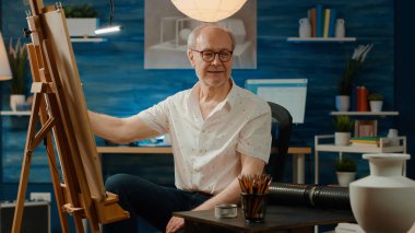 Senior man drawing vase model on canvas with artistic tools and skills, looking at inspiration design to create professional artwork. Using creativity and pencils to draw sketch masterpiece.