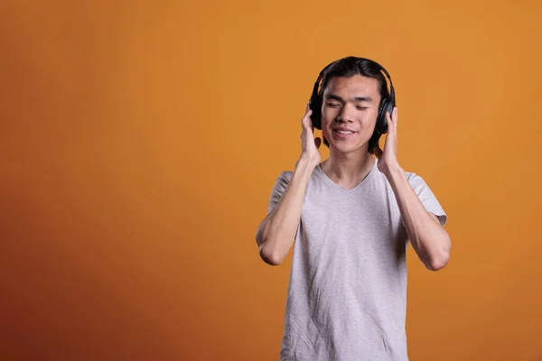 Young Adult Asian Man Enjoying Music Wireless Headphones Satisfied Facial —  Fotos de Stock