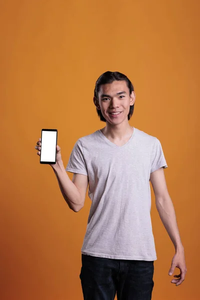 Asian Teenager Showing Smartphone White Blank Screen Young Man Holding — Zdjęcie stockowe