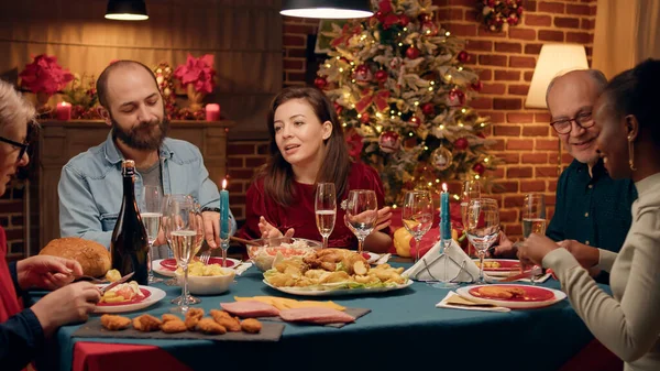 Happy Wife Talking Guests Food While Sitting Together Christmas Dinner — Stock Fotó