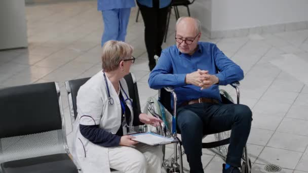 Wheelchair User Caretaker Having Consultation Medic Waiting Area Facility Old — Stock video