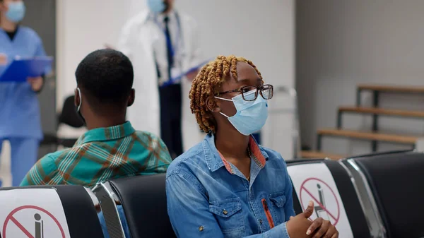 Female Patient Face Mask Sitting Waiting Room Area Having Consultation — Stockfoto