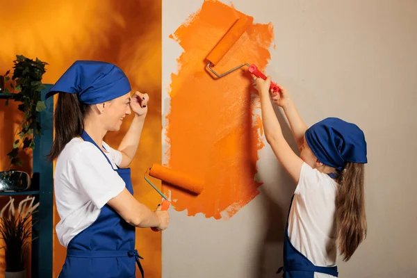 Mom Kid Painting Walls Orange Color Paint Using Renovating Tools — Stok fotoğraf