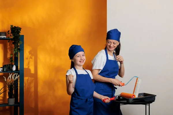Portrait Cheerful Family Painting Room Using Orange Color Paint Roller — 스톡 사진