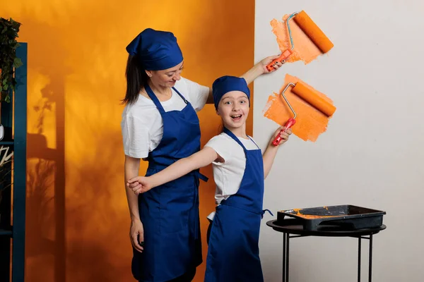 Happy People Painting Orange Walls Redecorate House Room Using Renovating — 스톡 사진