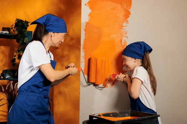 Young People Using Orange Color Paint Renovating Apartment Walls Painting — Stockfoto