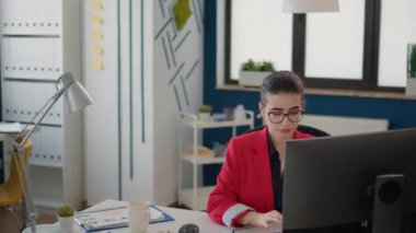 Business woman working on project with marketing statistics in startup office. Sales assistant planning analysis with charts and diagrams on computer, using data for company development.