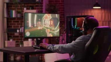 Streamer unhappy and disappointed after failing level in action game tournament challenge on gaming pc at home. Man playing online first person shooter angry after losing online competition.