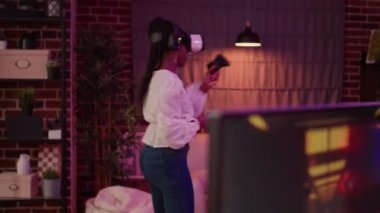 African american woman fighting in virtual reality game on console while boyfriend is playing online multiplayer rpg on pc. Gamer girl uses vr goggles while man is streaming first person shooter.
