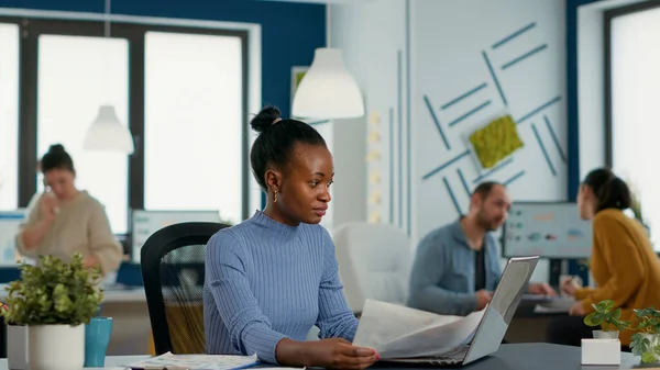 African American Startup Employee Holding Business Papers Charts Looking Laptop — Foto Stock