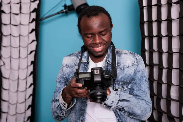 Smiling Photographer Checking Camera Gallery While Standing Production Studio Equipped — Fotografia de Stock