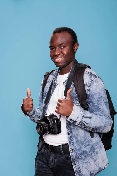 Smiling Young Man Professional Camera Giving Thumbs Hand Symbol While — Stockfoto