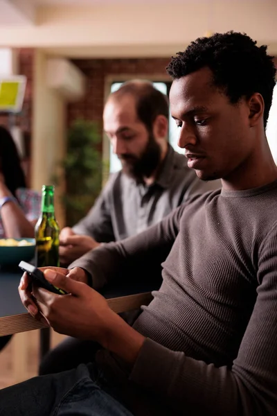 African American Man Modern Touchscreen Smartphone Sitting Table While Browsing — Fotografia de Stock
