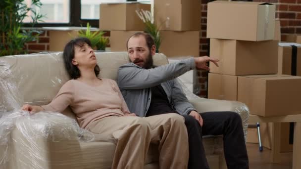 Married Couple Feeling Tired Unpacking Furniture Moving New Rented Apartment — Vídeo de stock