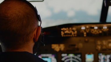 Male aviator using handle and windscreen in cockpit to fly airplane, throttling power engine to takeoff. Commanding aircrew and using control panel dashboard. Close up. Handheld shot.